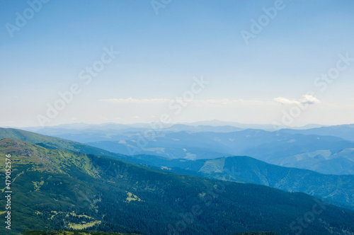 silhouettes of mountain peaks in the morning blue fog, beautiful landscape, travel. High quality photo