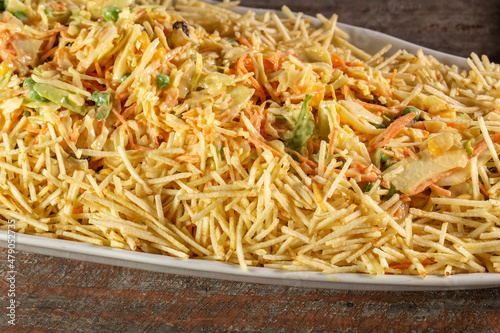 Chicken salad. Salpicão is a typical Brazilian salad, made with shredded chicken, raisin, grated carrot, potato sticks and mayonnaise.