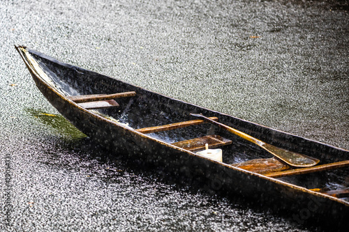 Handmade wooden boat alone in the heavy rain tranquil