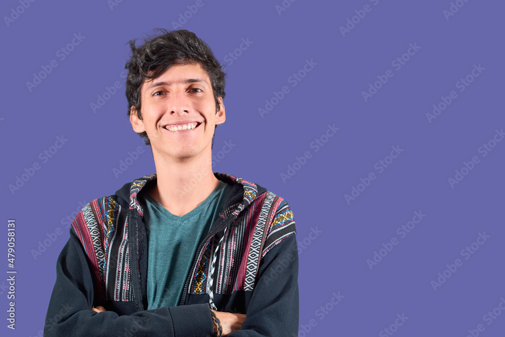 Young latin man smiling looking at the camera with mexican clothes. Isolated in flat background. Young latin man smiling looking at the camera with mexican clothes. Isolated in flat background.