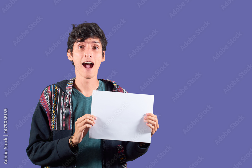 Young Latino man caught holding blank poster. Young Latino man caught holding blank poster.