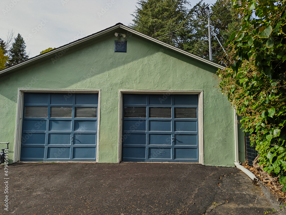 Light green building with blue garage doors Light green building with blue garage doors