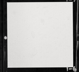 close up, real flat bed scan of black and white hand copy contact sheet with 1 empty film frame and nice paper structure, 120mm film photo placeholder.	