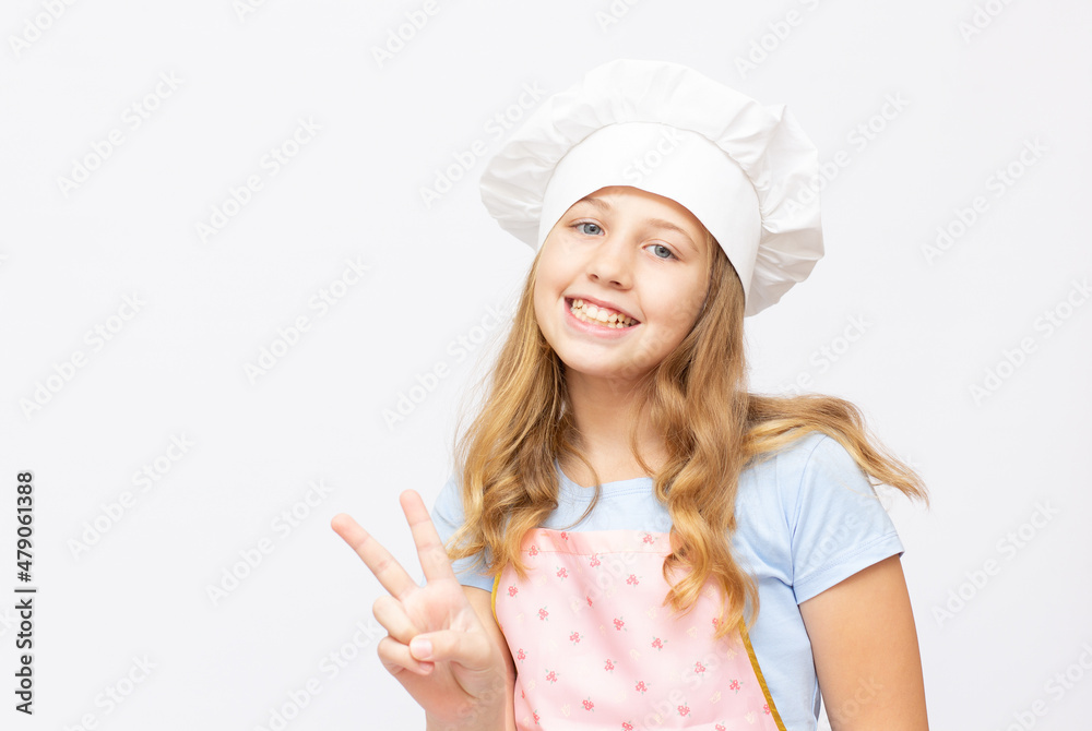 Beautiful little girl in chef uniform isolated on white copy space banner Beautiful little girl in chef uniform isolated on white copy space banner