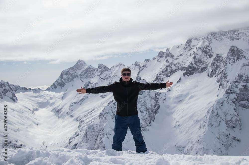 Portrait of a man on top of a snowy mountain