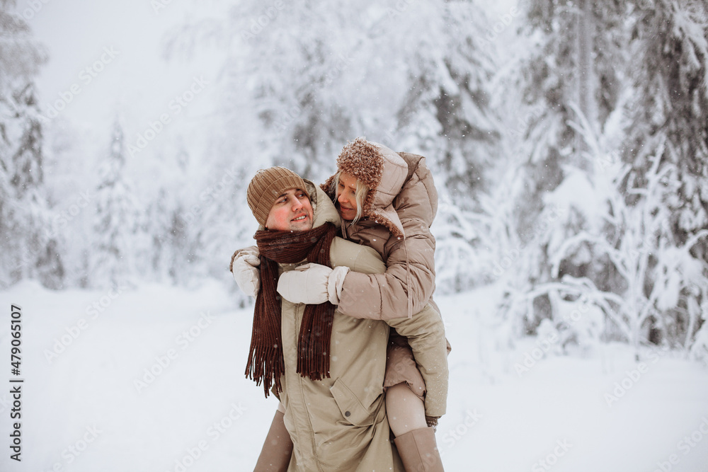 Couple in love walks in the winter forest Couple in love walks in the winter forest