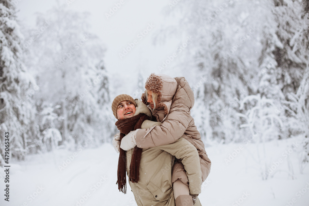 Couple in love walks in the winter forest Couple in love walks in the winter forest