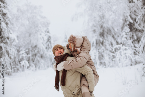 Couple in love walks in the winter forest