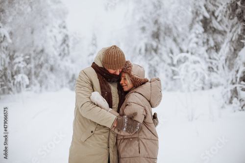 Loving couple hugging in the winter forest