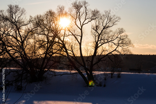 Winter landscape of snowy river during sunset