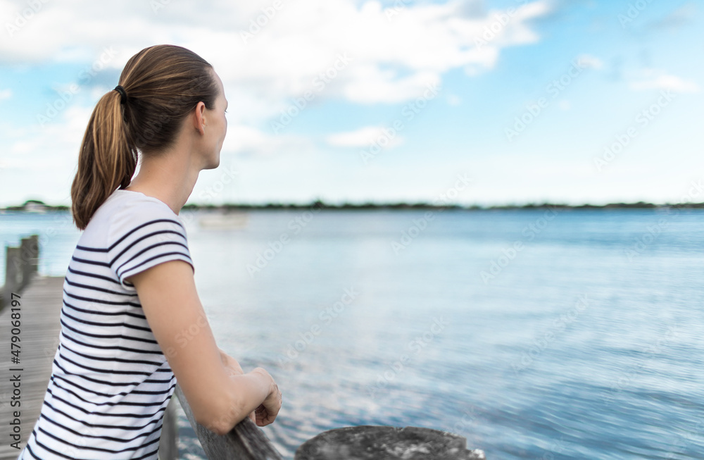 woman on the beach looking out at the nature view 