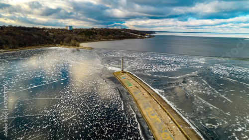 Aerial view of a sea lighthouse in the middle of ice