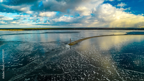 Aerial view of a sea lighthouse in the middle of ice