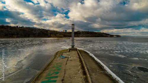 Aerial view of a sea lighthouse in the middle of ice