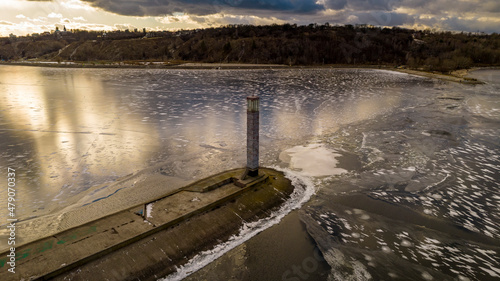 Aerial view of a sea lighthouse in the middle of ice