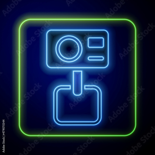 Glowing neon Action extreme camera icon isolated on blue background. Video camera equipment for filming extreme sports. Vector