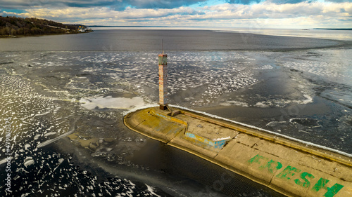 Aerial view of a sea lighthouse in the middle of ice