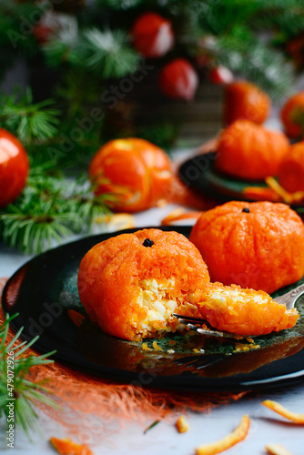 Imitation tangerines with a snack inside. Vertical composition. New Year's decor. Closeup