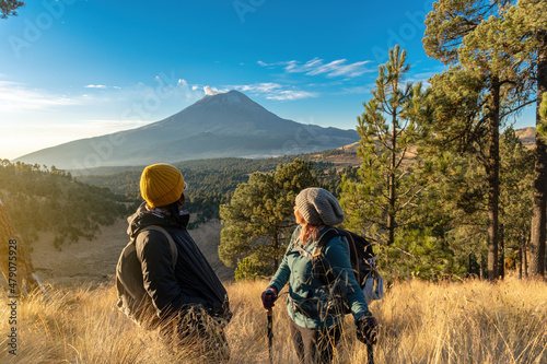 happy female hikers with the popocatepetl volcano in the background