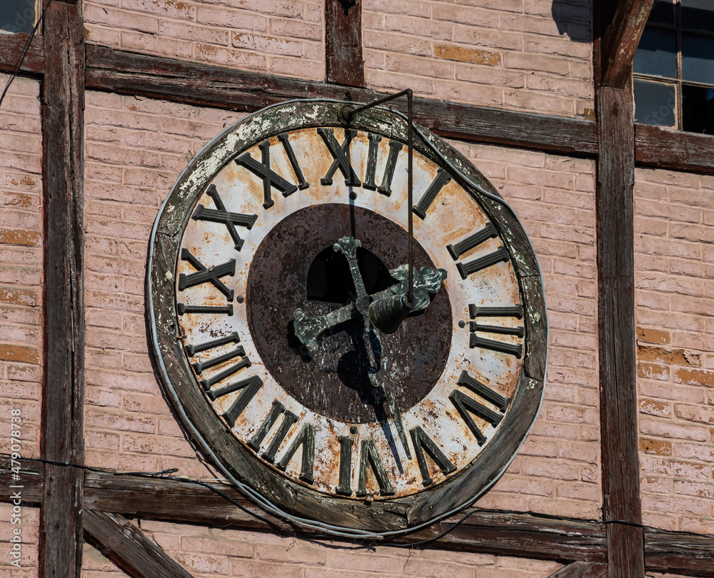 clock face on old wooden tower close up. Ukraine, Chortkiv