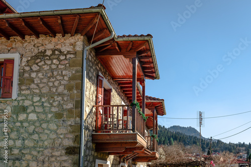Traditional 2-storey stone house with wooden balcony in Elati, a mountainous village in the Trikala Prefecture, Greece. Elati is a popular tourist destination and resort during the whole year. photo