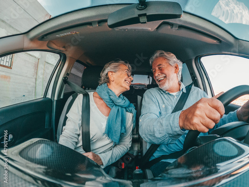 Couple of two happy senior having fun and enjoying vacations trip together driving and discovering new places with a car. 
 photo