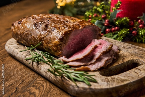 Sliced Baked roast meat, isolated on wooden background. High quality photo