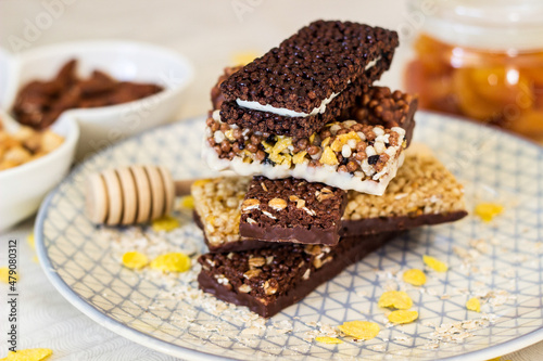 Granola energy bar with mix of nuts and fruits on a plate