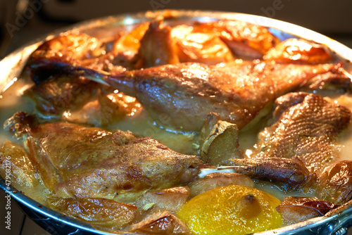 the duck lies in a skillet in the oven