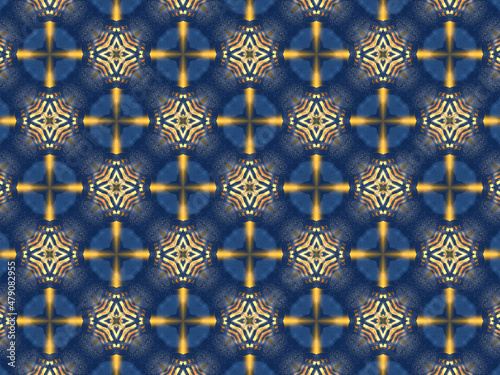 Repeating kaleidoscopic pattern with abstract flowers and light effects. A yellow/navy pattern for surface design. Concept of night and lighting. Concept of the dark and the light.