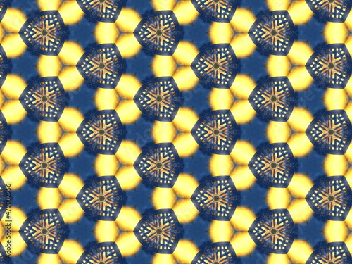 Repeating kaleidoscopic pattern with abstract flowers and light effects. A yellow/navy pattern for surface design. Concept of night and lighting. Concept of the dark and the light.