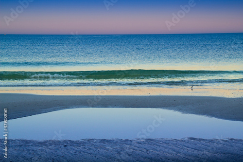 Early morning Clearwater Beach on the west coast of Florida dispalys a range of tones as the sun rises and the water meets the sand and sky