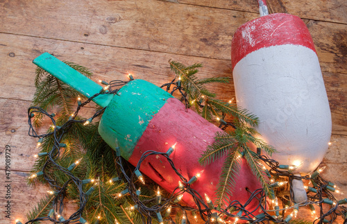 Colorful Maine Red green and white lobster float buoys surrounded by Christmas holiday lights photo