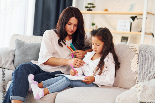 Modern design. Mother and her daughter spending time together at home
