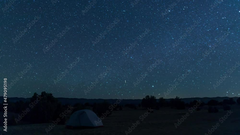 A night-to-day time-lapse of a tent under a star-filled night sky in the Grand Staircase-Escalante National Monument a few miles south of the town of Escalante, Utah. 