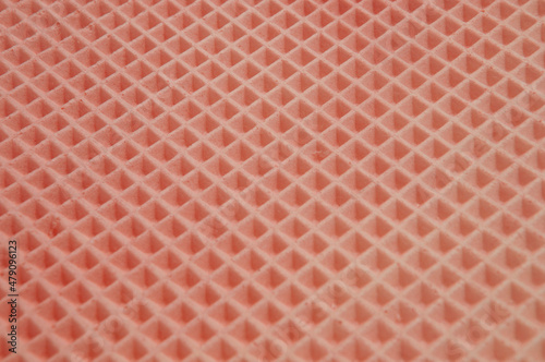 waffle cake close up. red checkered background. geometric volumetric texture.