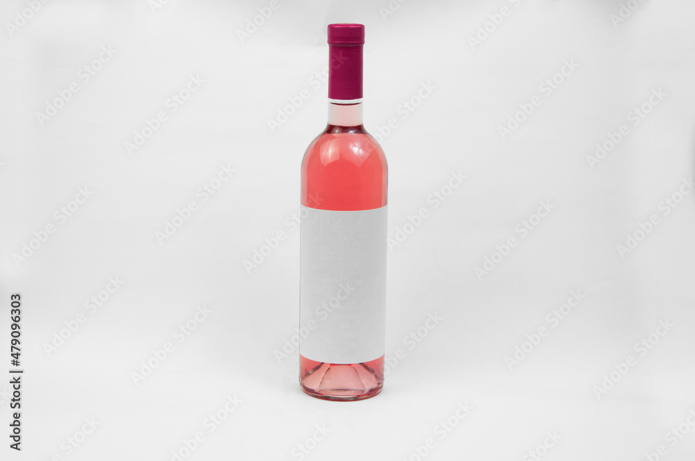 bottle of wine on a light background. bottle with liquor on a white surface. grape harvest concept. bottle of wine on a light background. bottle with liquor on a white surface. grape harvest concept.