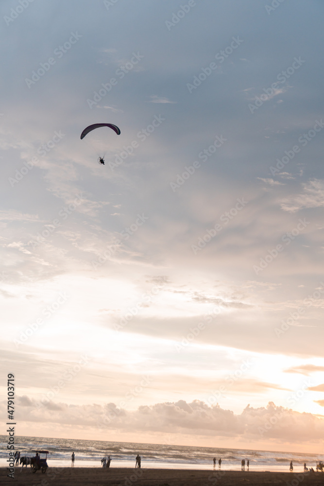 Powered parachute always adorns the sky of Parangtritis beach, Yogyakarta, Indonesia Powered parachute always adorns the sky of Parangtritis beach, Yogyakarta, Indonesia