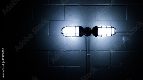 Obraz na płótnie Dark creepy basement bunker concrete block wall and glowing old lamp light backg