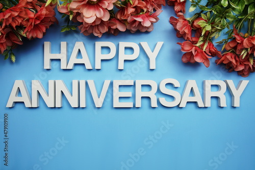 Happy Anniversary alphabet letters decorate with flowers on blue background © may1985