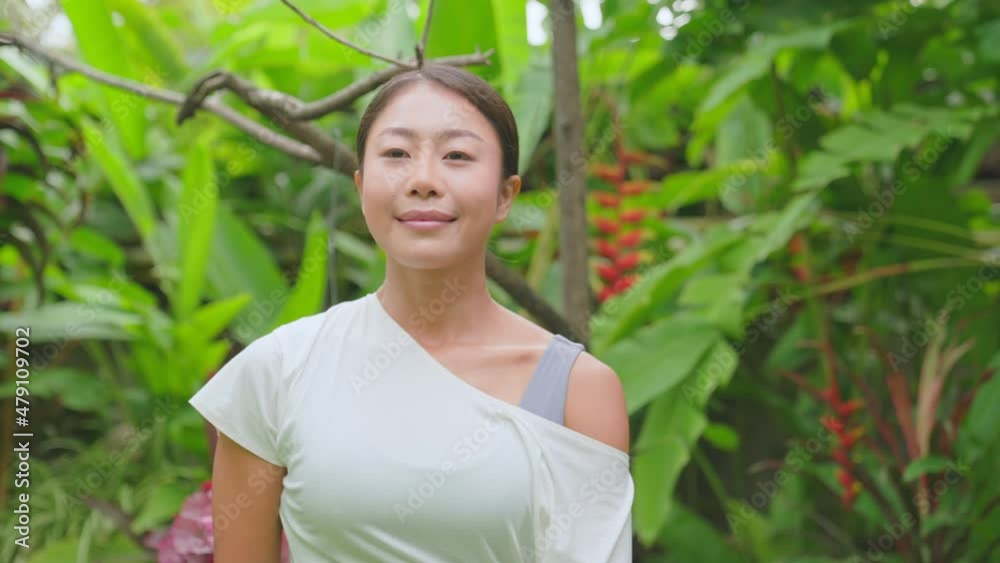 An Asian woman practices yoga outdoors to keep calm and meditate while practicing yoga for strength and flexibility of muscles and tendons. exercise, fitness and lifestyle. Sport and healthy concept. An Asian woman practices yoga outdoors to keep calm and meditate while practicing yoga for strength and flexibility of muscles and tendons. exercise, fitness and lifestyle. Sport and healthy concept.