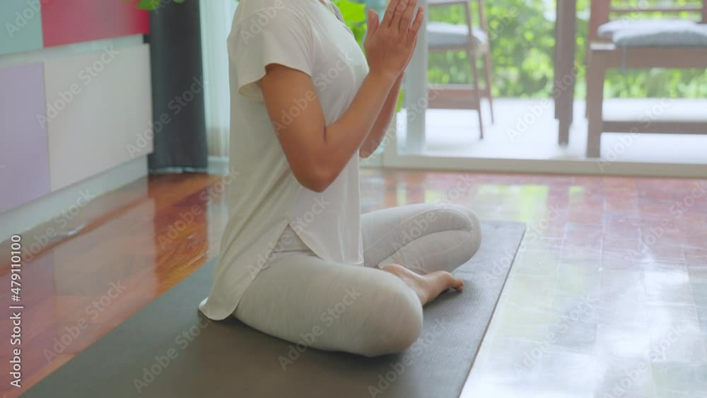 Happy Asian beautiful woman practicing yoga, sports, exercise, fitness, stretching muscles and tendons. A female practice control of breathing in and out. Lotus post and health care with yogi concept.