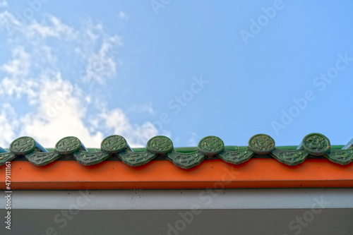 The roof of a house with a Chinese ornament