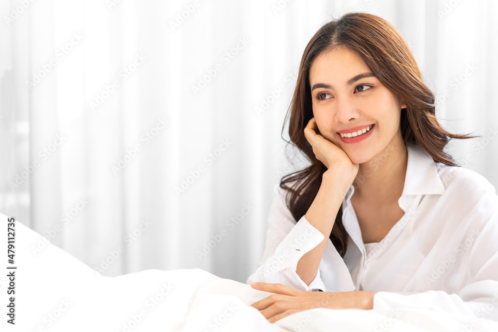 Portrait of smiling cheerful beautiful pretty asian woman clean fresh healthy white skin posing in pajamas white clothes.Girl felling relaxing and enjoy time on the bed at home.asia beauty Portrait of smiling cheerful beautiful pretty asian woman clean fresh healthy white skin posing in pajamas white clothes.Girl felling relaxing and enjoy time on the bed at home.asia beauty