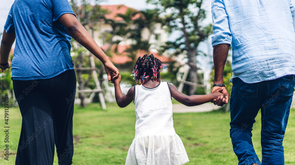 Portrait of enjoy happy love black family african american father and mother with little african girl child smiling and play having fun moments good time in summer park at home