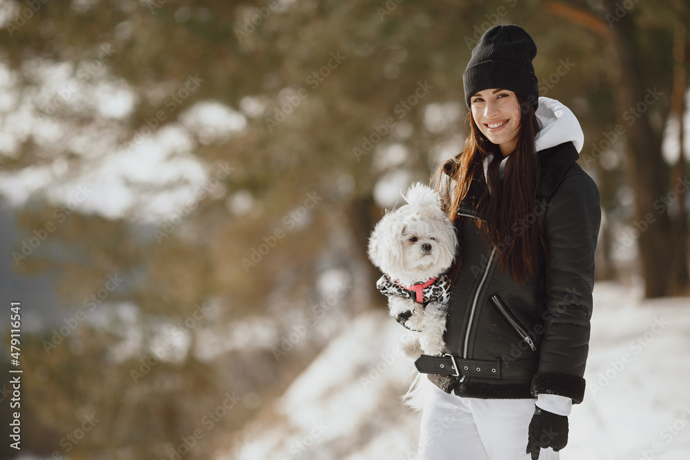 young woman hugging her dog close up outdoors