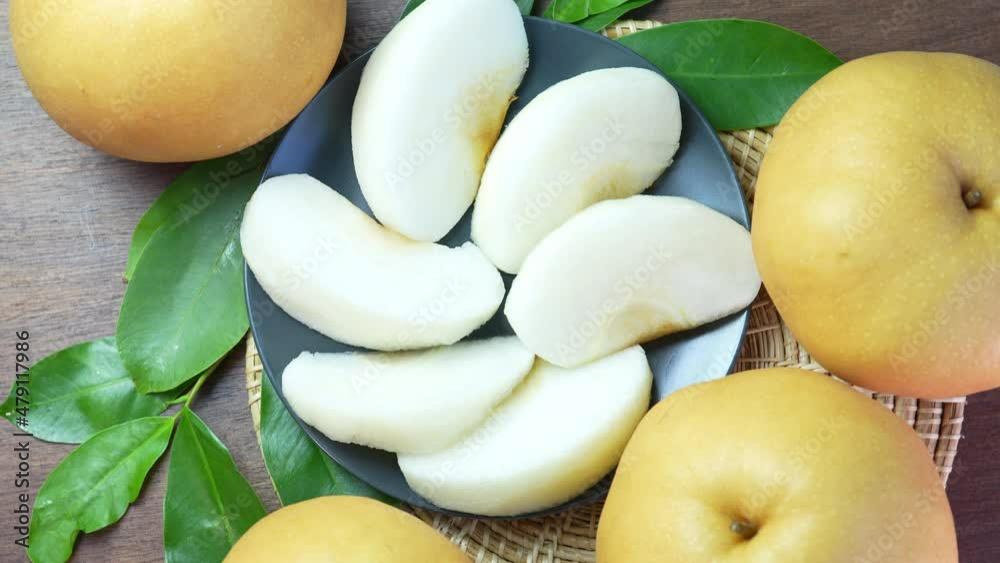 Snow pear fruit on wooden background, Fresh Nashi pear or Korean pear fruit rotation. Snow pear fruit on wooden background, Fresh Nashi pear or Korean pear fruit rotation.