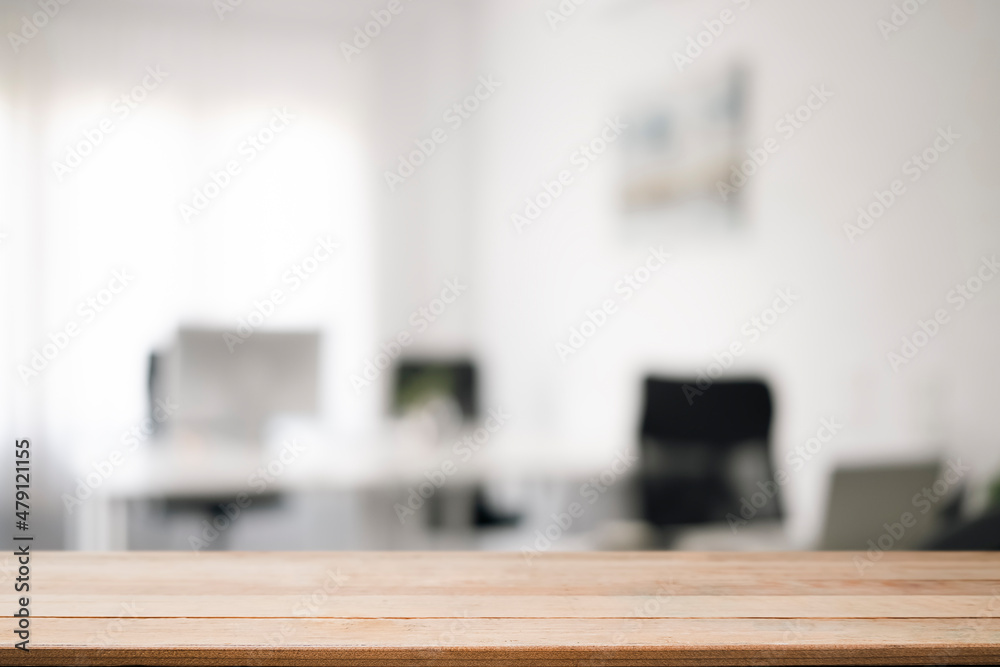 Empty wooden table with blurred modern office background. Copy space for display of product.