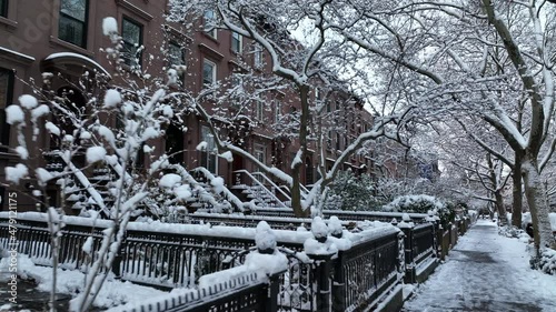 moving backward along snow covered sidewalk in Carroll Gardens Brooklyn photo