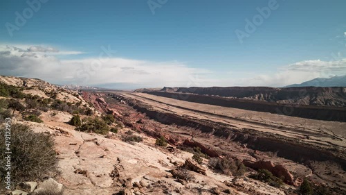 A daytime time-lapse of the Waterpocket Fold, a 100-mile long geological feature in Capitol Reef National Park in Utah. Clouds move west to east towards the Henry Mountains. photo